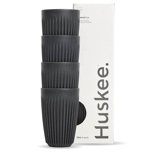 Pack of 4, 12oz Charcoal Huskee reusable coffee cups stacked in front of packaging box