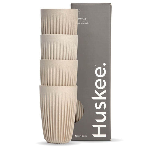 Pack of 4, 12oz Natural Huskee reusable coffee cups stacked in front of packaging box
