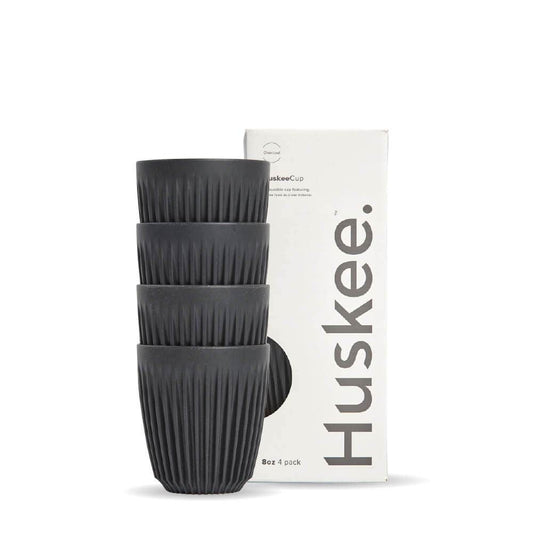 Pack of 4, 8oz Charcoal Huskee reusable coffee cups stacked in front of packaging box
