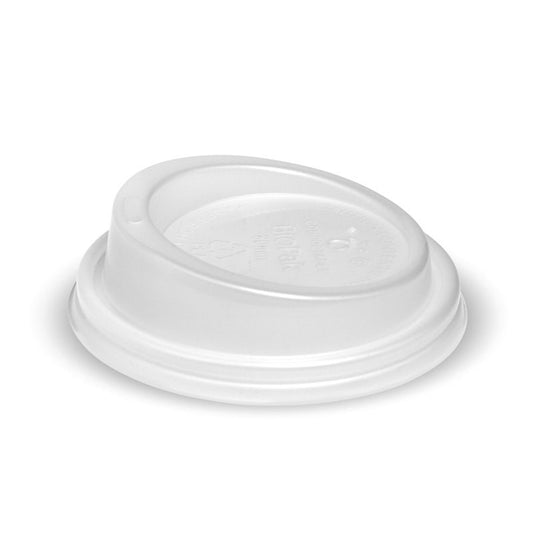 |hand holding a kraft coffee cup with white PLA lid on top of a table
