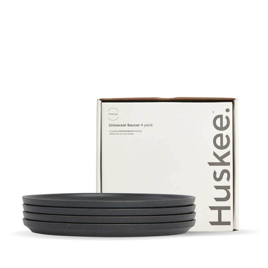 4-pack of Charcoal HuskeeCup Classic Saucers in front of packaging box