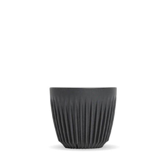 6oz Charcoal Huskee reusable coffee cup|Pack of 4, 6oz Charcoal Huskee reusable coffee cups stacked in front of packaging box